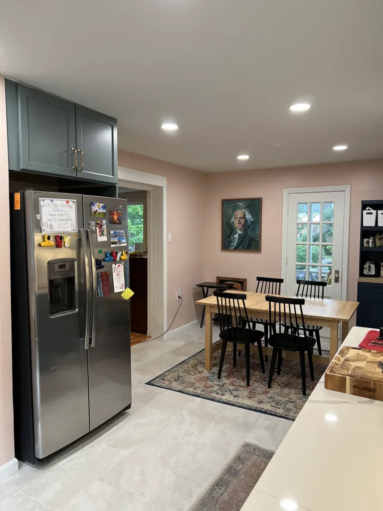 Two-tone kitchen renovation in Arlington, VA with sage green J&K cabinets, white uppers and porcelain floor tile by Kitchen & Bath Masters
