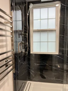Bathroom Design in Arlington, VA Elena C. 5 Black marble-look porcelain shower with window and linear drain in an Arlington bathroom