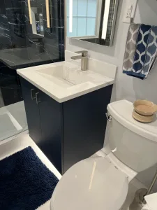Bathroom Design in Arlington, VA Elena C. 8 Navy vanity with white integrated sink and seamless white epoxy floor in an Arlington bathroom