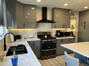 Black faucet and sink with a full-height quartz backsplash in a Greenbelt kitchen