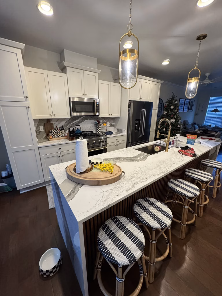 Kitchen update in Arlington, VA with a Cambria quartz waterfall island and slat panel base by Kitchen & Bath Masters