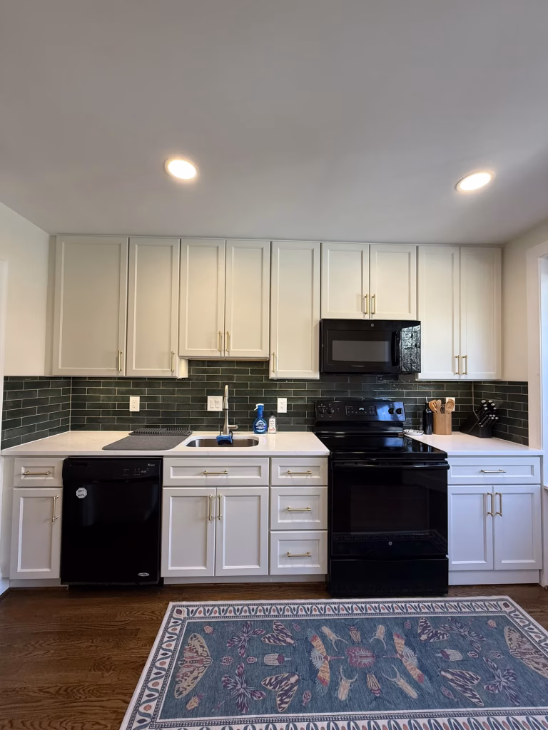 Kitchen remodel in Annandale, VA with Dove J&K Cabinetry, quartz countertops and green subway tile backsplash by Kitchen & Bath Masters
