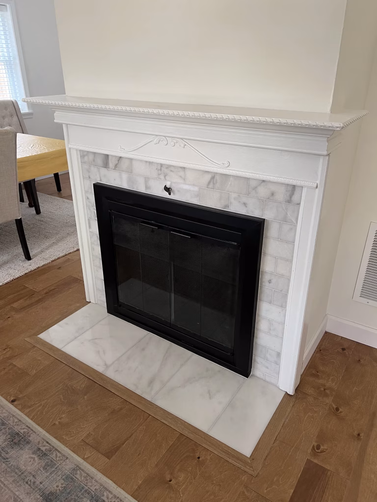 Finished fireplace with marble-look subway tile surround, white mantel and tile hearth in Alexandria, VA