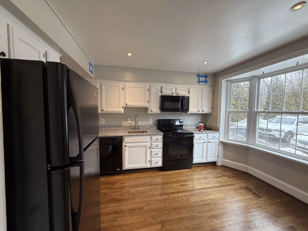 J&K Cabinetry Kitchen Remodeling with Green Backsplash in Annandale, VA | Erin H. Project 1 Outdated builder-grade kitchen cabinets prior to remodeling in Annandale, VA