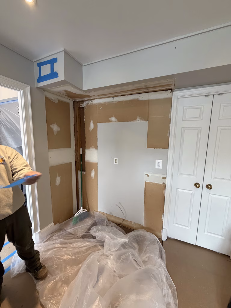 J&K Cabinetry Kitchen Remodeling with Green Backsplash in Annandale, VA | Erin H. Project 11 Kitchen and Bath Masters team removing a bulkhead during a kitchen remodel in Annandale, VA
