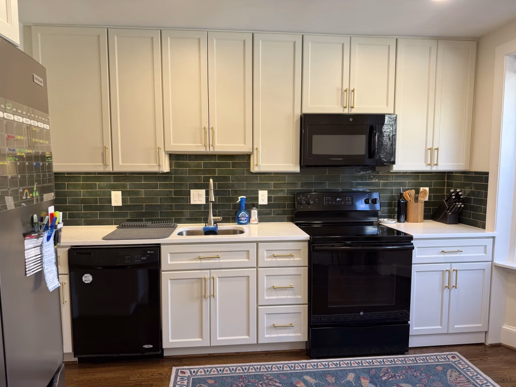 J&K Cabinetry Kitchen Remodeling with Green Backsplash in Annandale, VA | Erin H. Project 4 Modern kitchen design showing toe-kick drawers and dark green tile backsplash in Annandale, VA