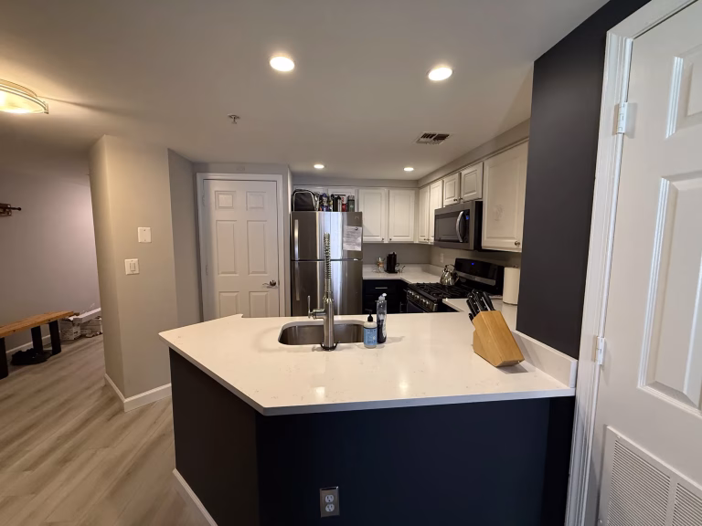 Kitchen countertop replacement in Arlington, VA with new white MSI quartz on the peninsula by Kitchen & Bath Masters