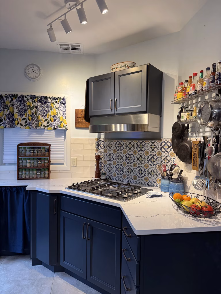 Kitchen remodel in Arlington, VA with navy blue Waypoint shaker cabinets and patterned tile backsplash by Kitchen & Bath Masters
