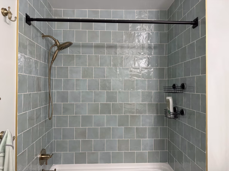 Guest bathroom remodel in Arlington, VA with sage green square tile tub surround and brushed gold fixtures by Kitchen & Bath Masters